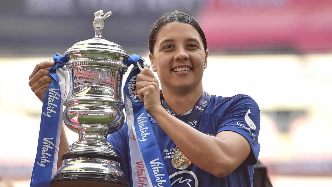 Sam Kerr holds the FA Cup for Chelsea. 