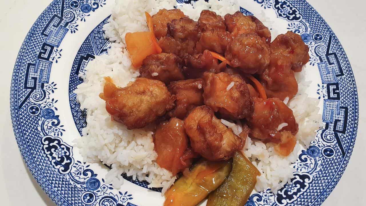 A stock image of sweet and sour pork with rice