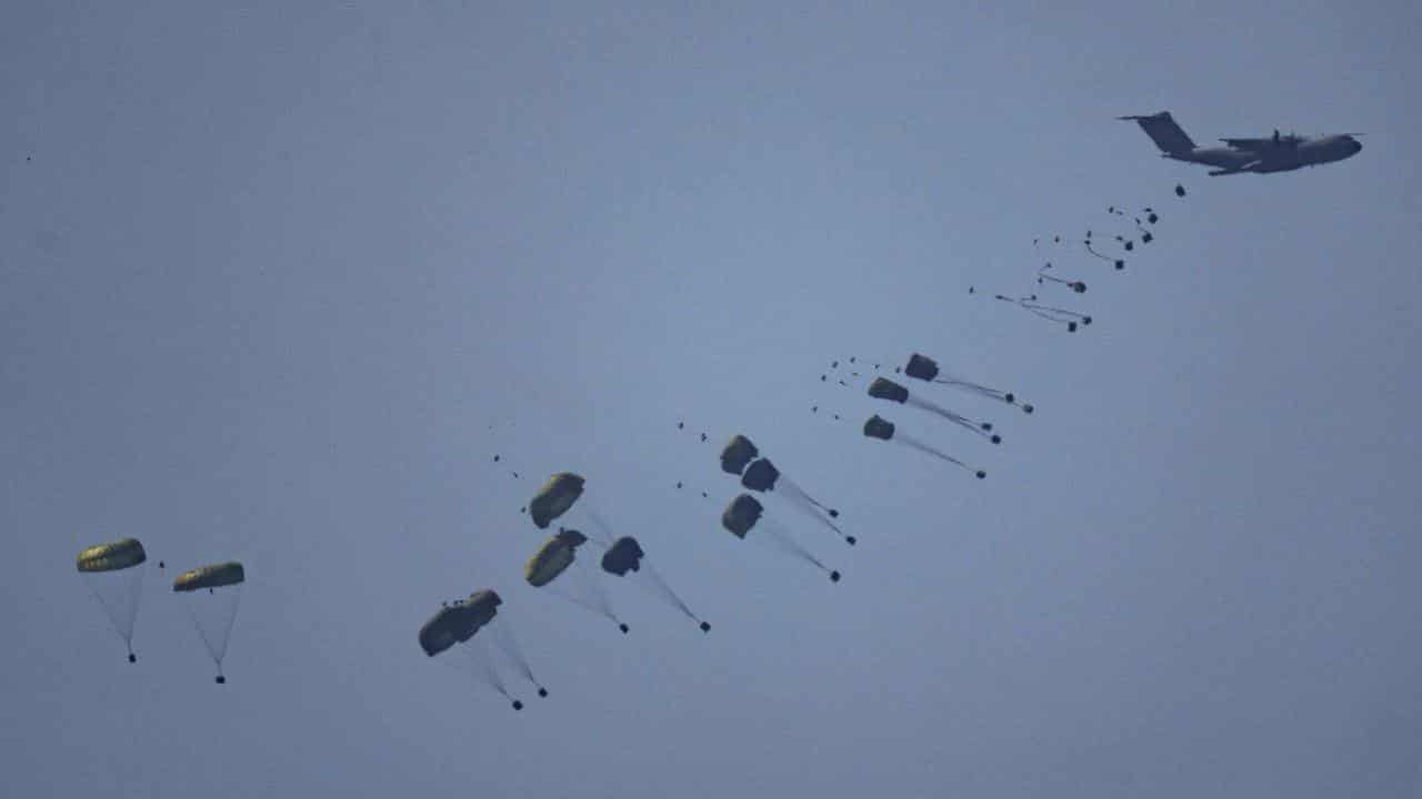 An aircraft airdrops humanitarian aid over Gaza