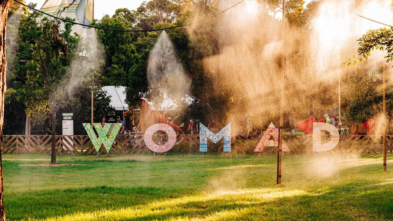 festivalgoers standing under water mist at the WOMADelaide event