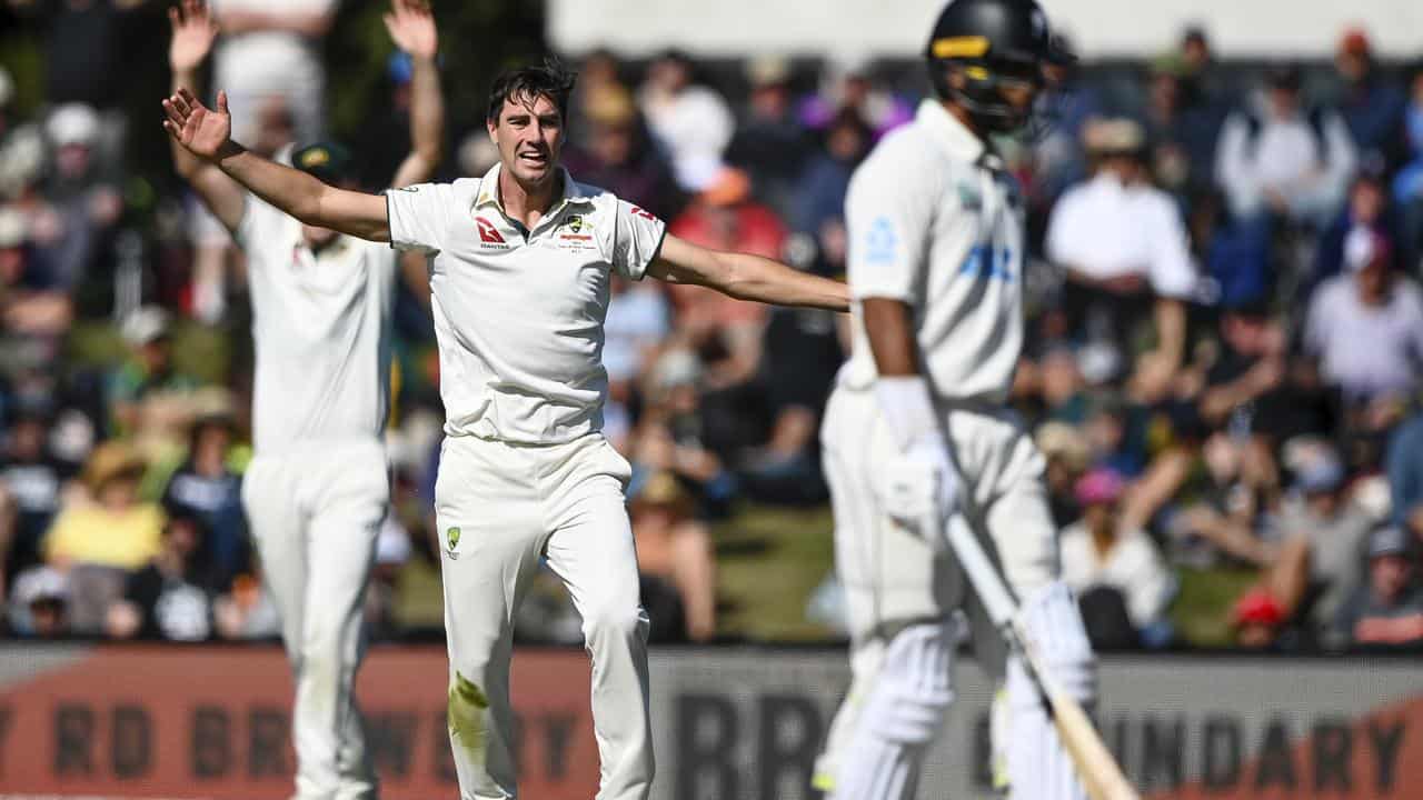 Pat Cummins appeals while bowling.