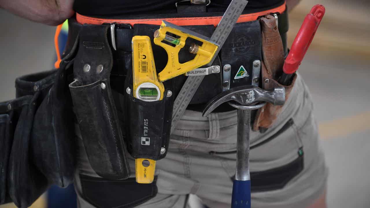 A carpenter wearing a tool belt