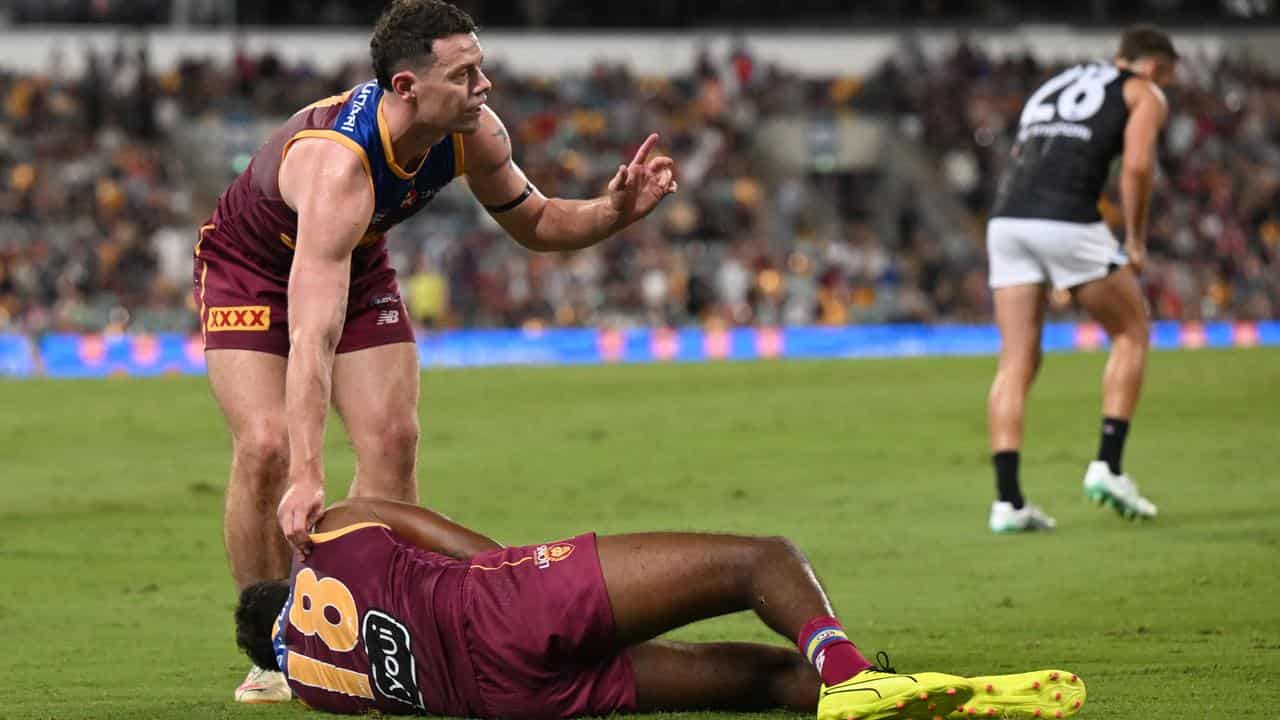 Lachie Neale calls for help for injured teammate Keidean Coleman.