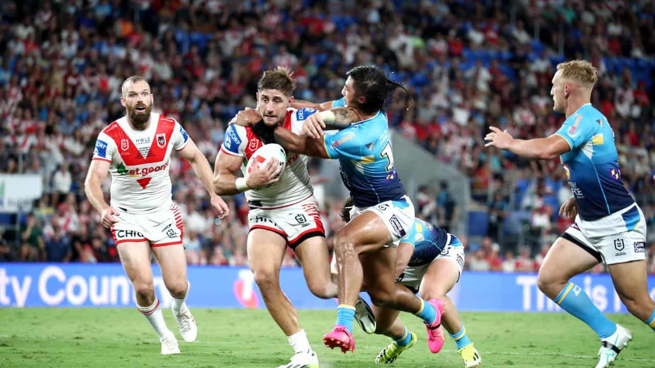 Zac Lomax (centre) of the Dragons in action against Gold Coast.