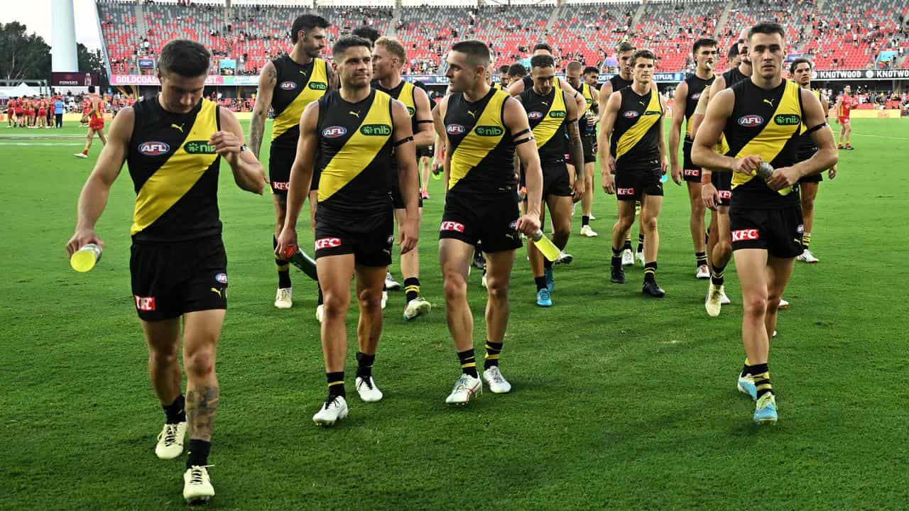 Disappointed Richmond players leave the field.