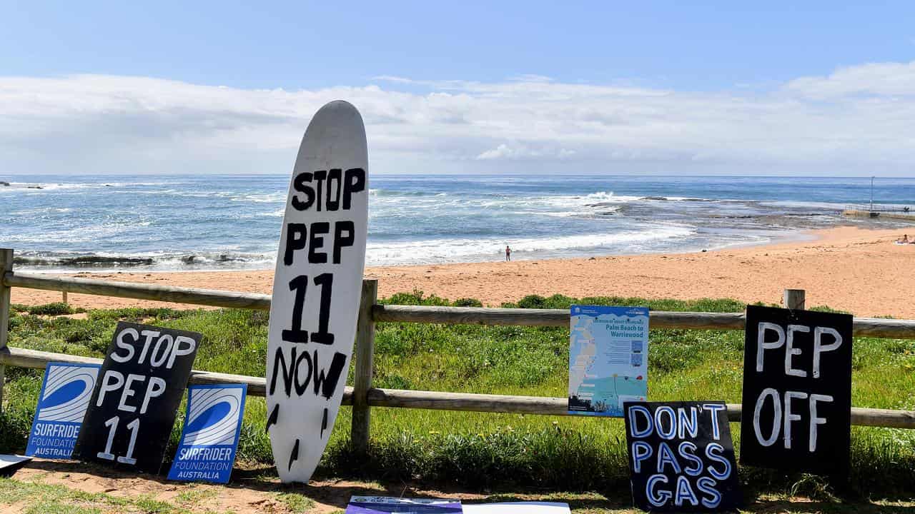 Signs against PEP-11 overlooking a beach in Sydney