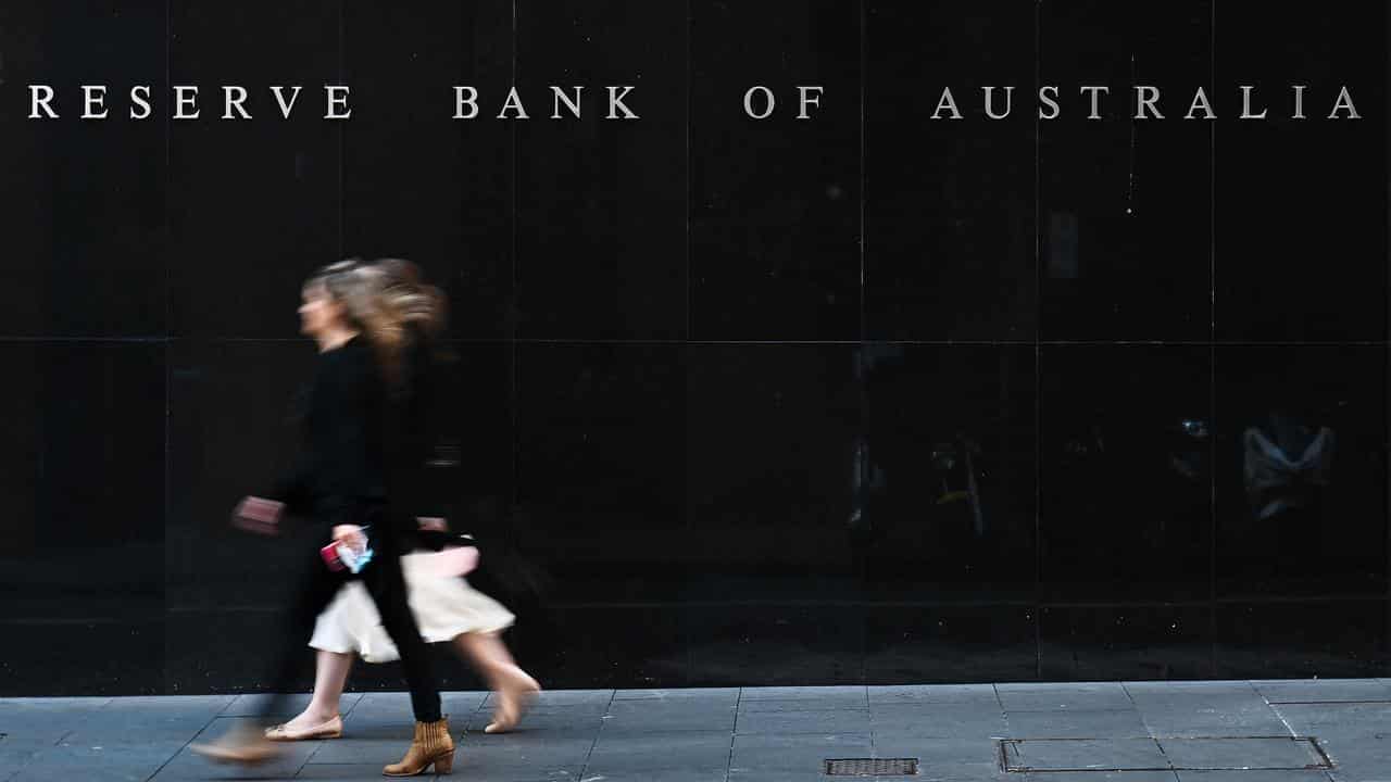 People  walk past the Reserve Bank of Australia