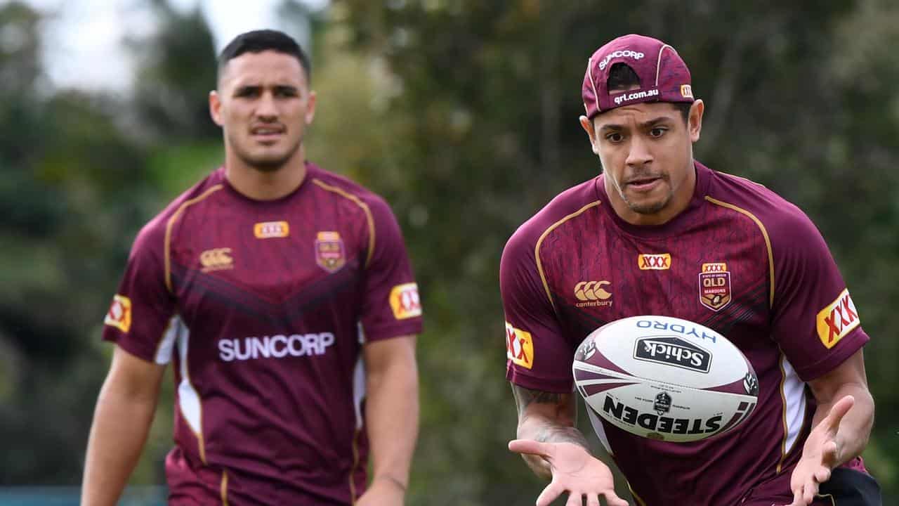 Valentine Holmes (left) watches Dane Gagai