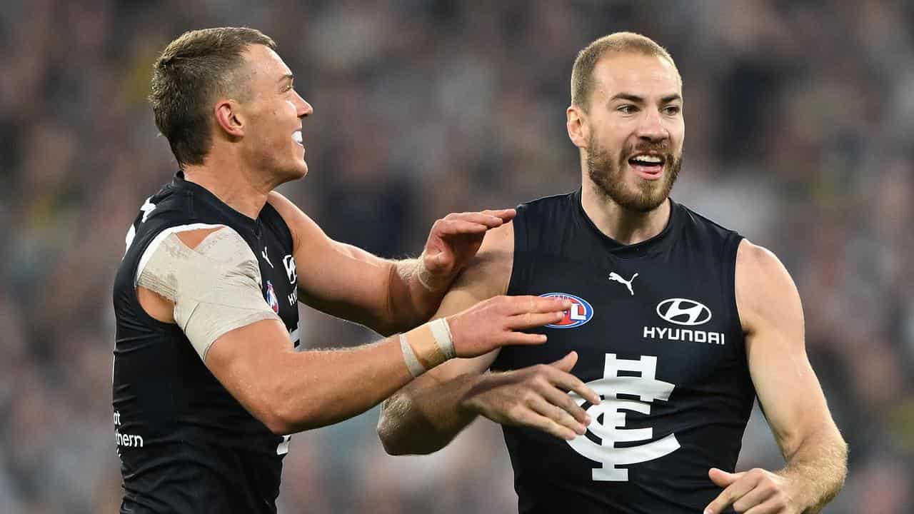 Patrick Cripps (left) congratulates Carlton teammate Harry McKay