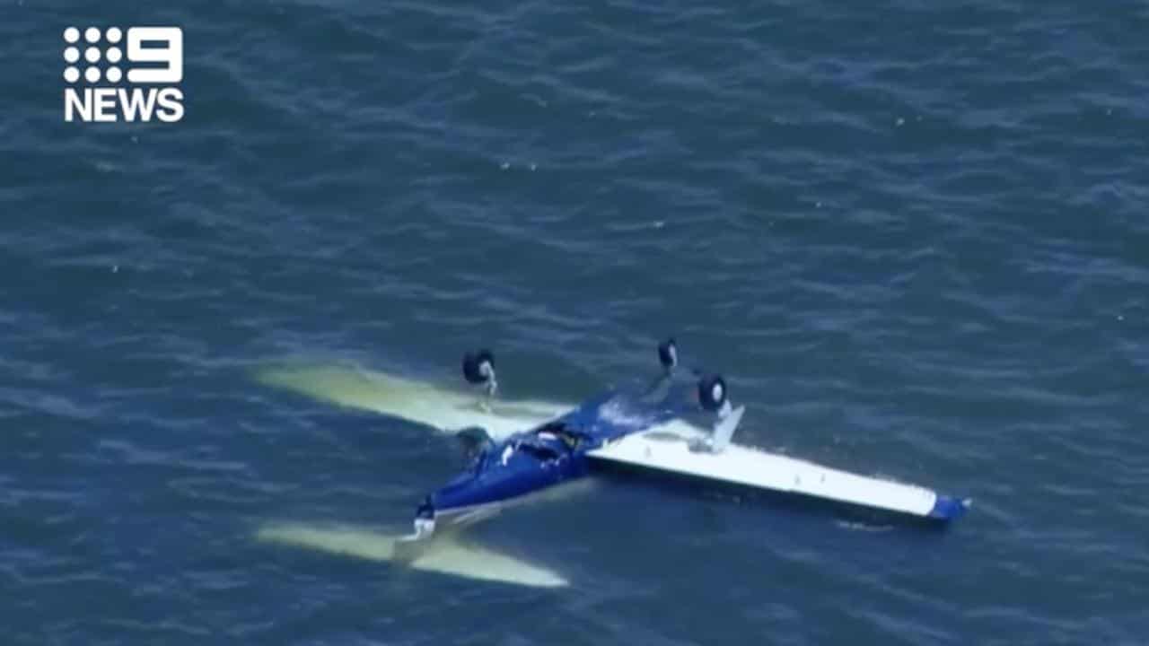 A light plane in water off the coast of Redcliffe