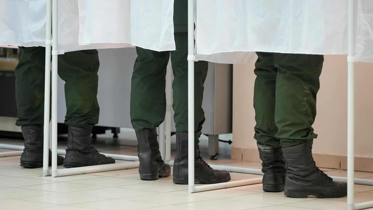 Russian servicemen fill their ballots in voting booths