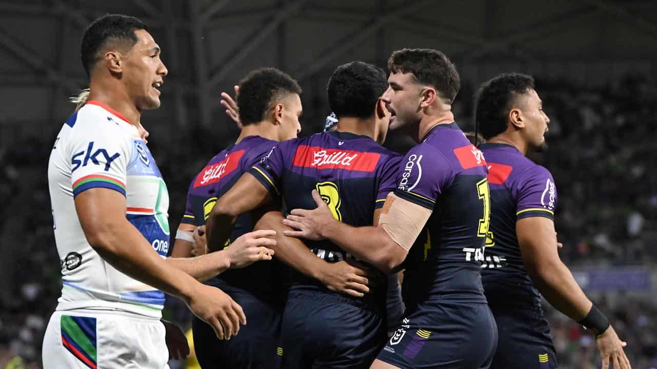 Melbourne Storm players celebrate a try.