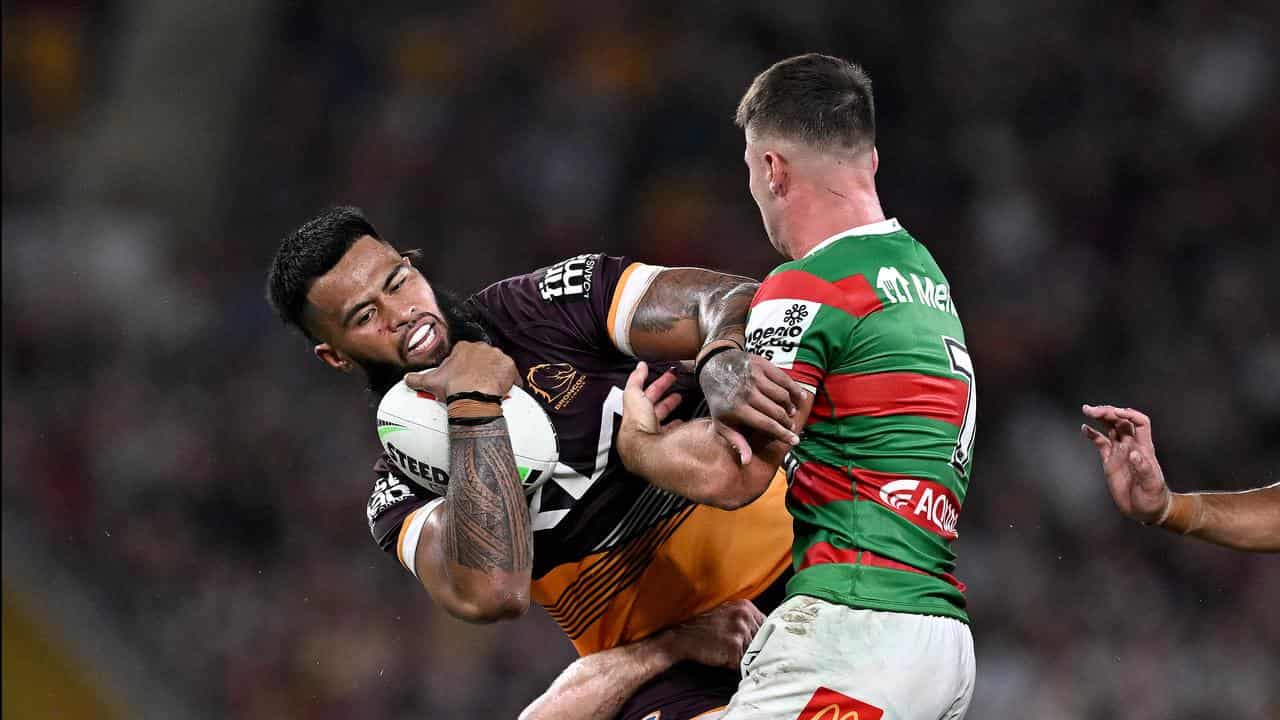 Payne Haas of the Broncos is tackled against South Sydney.