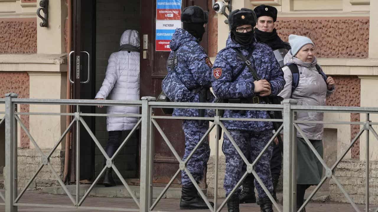 Russian Rosguardia servicemen stand guard at a pooling station