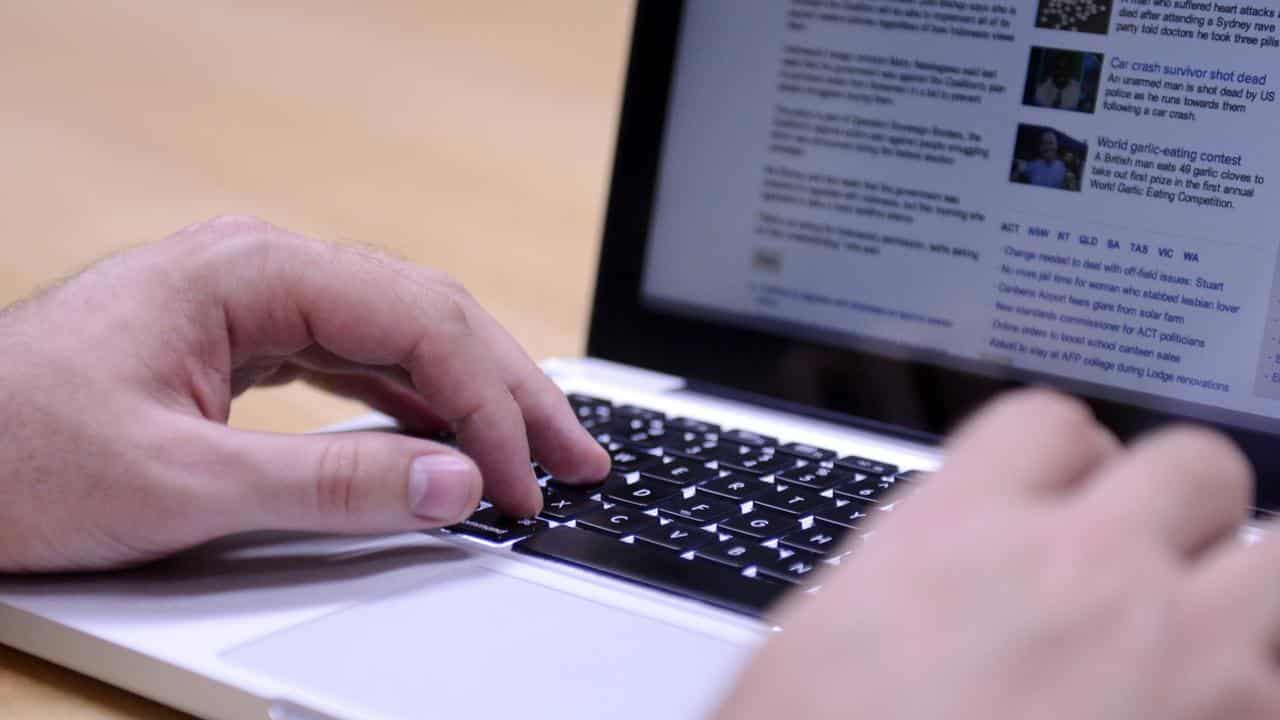 A man uses a laptop computer