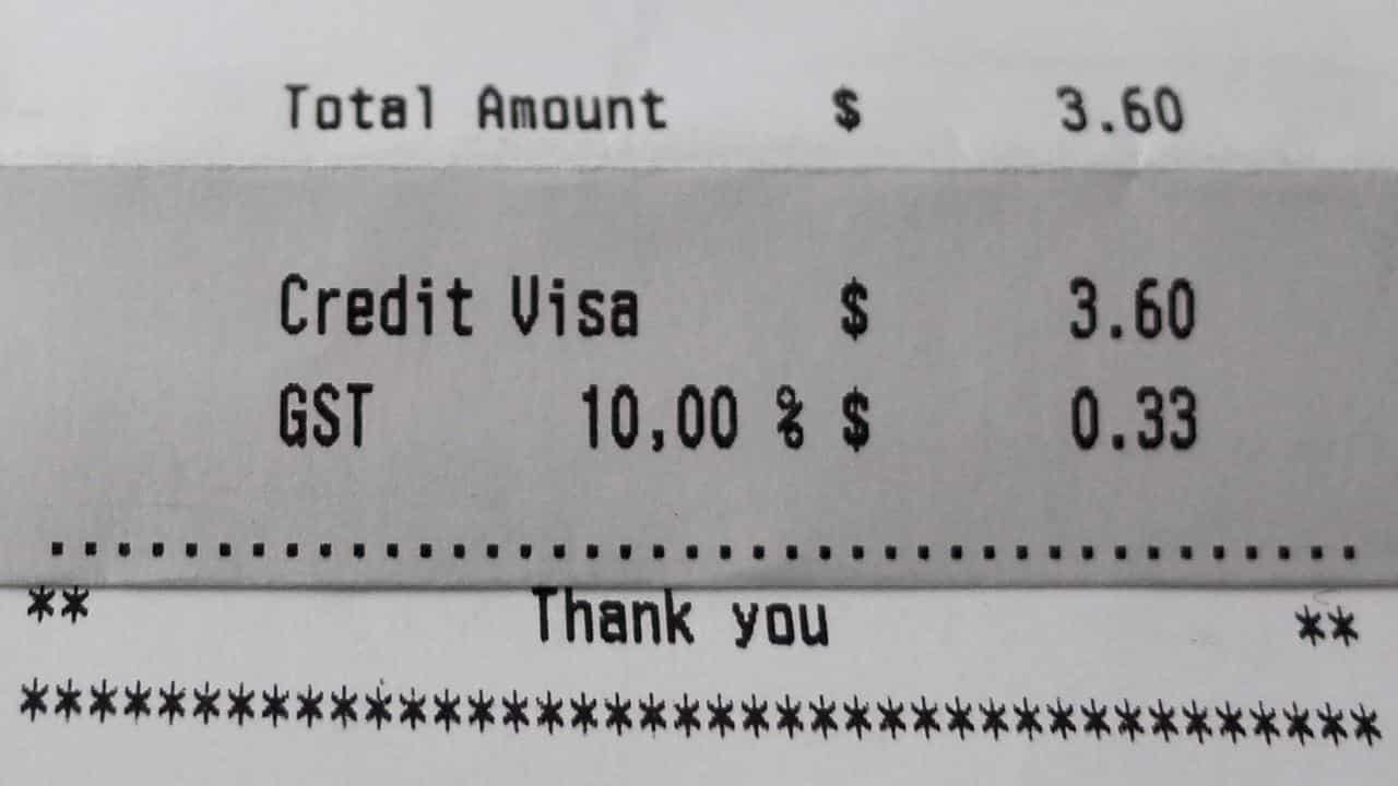 The GST component is seen printed on a parking receipt