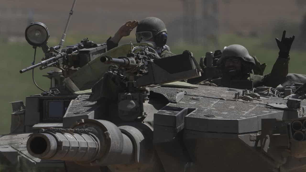 Israeli soldiers in a tank near the Israeli-Gaza border