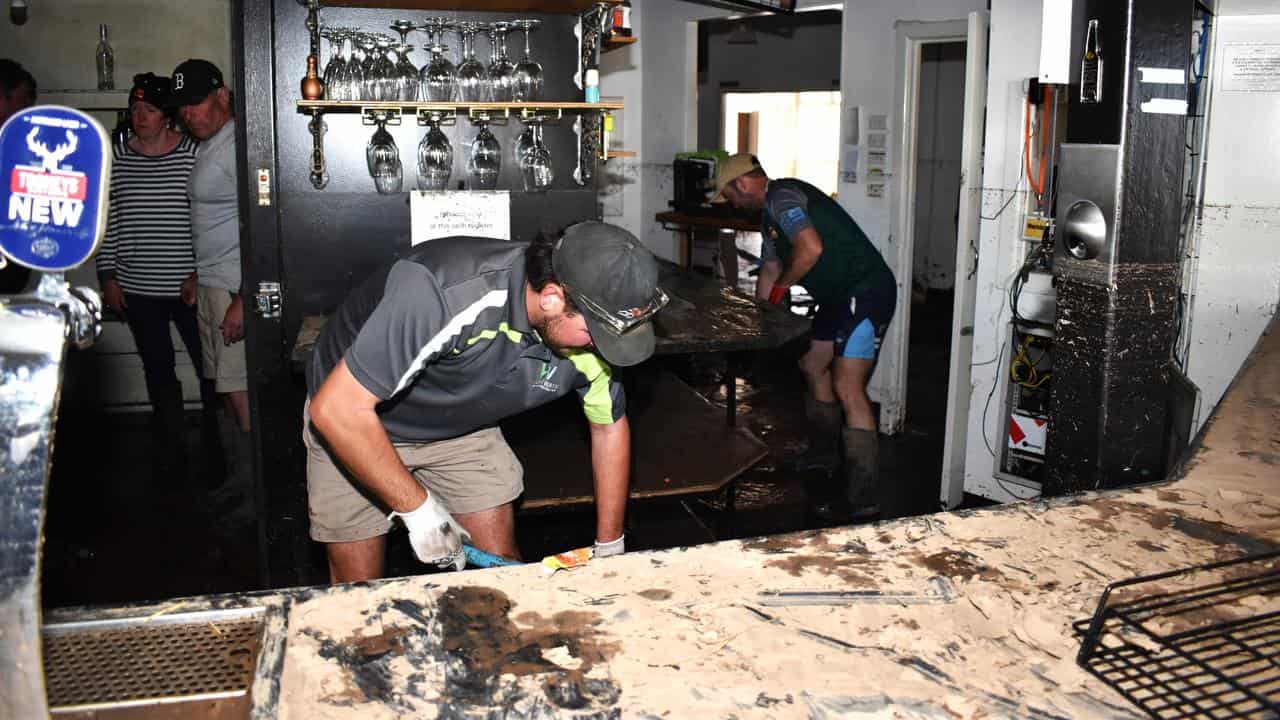 People cleaning up after floods