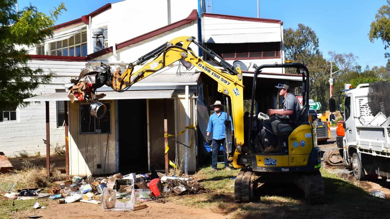 People clean up after flooding