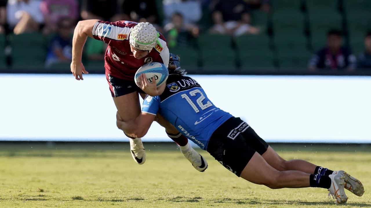 Mac Grealy of the Reds is tackled by Hamish Stewart of the Force.