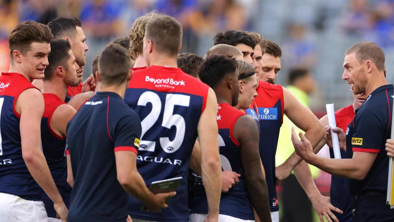 Melbourne head coach Simon Goodwin (right).