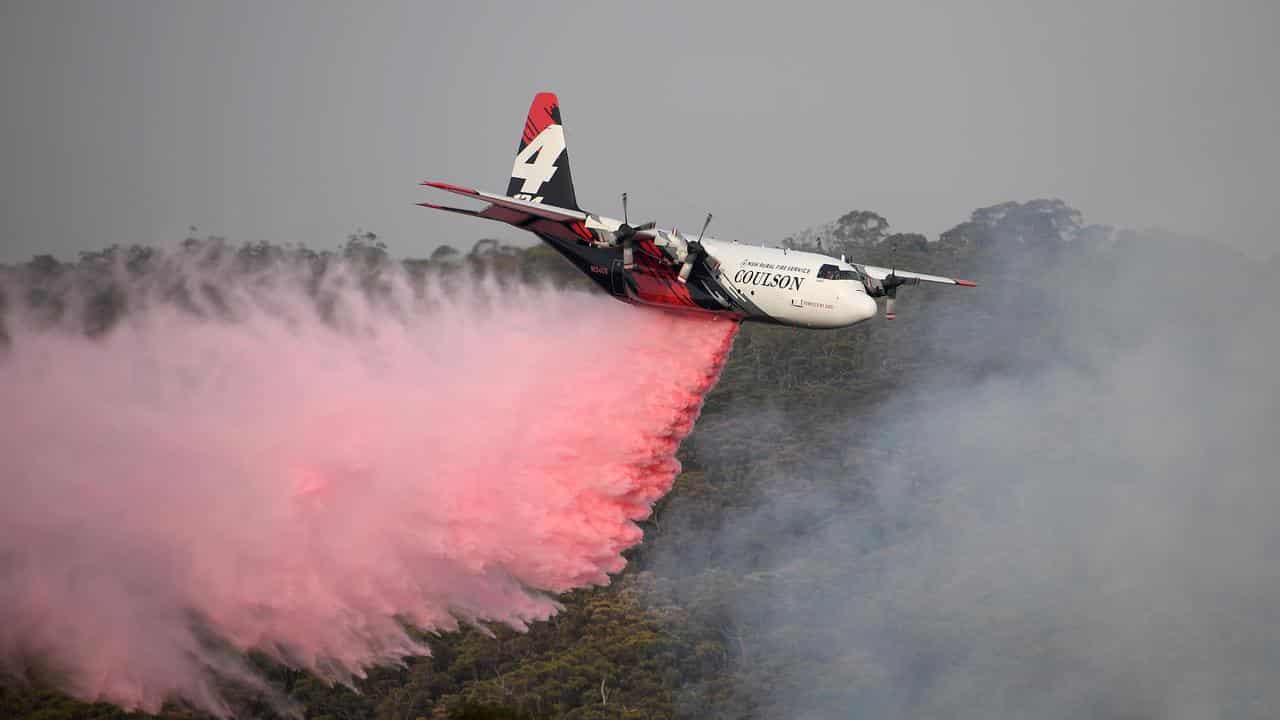 NSW Rural Fire Service air tanker drops retardant on a blaze in 2020