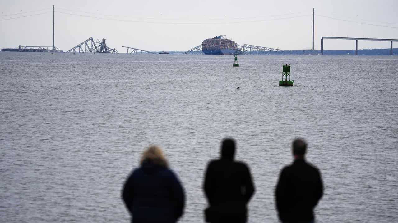 People view the wreckage of the Francis Scott Key Bridge