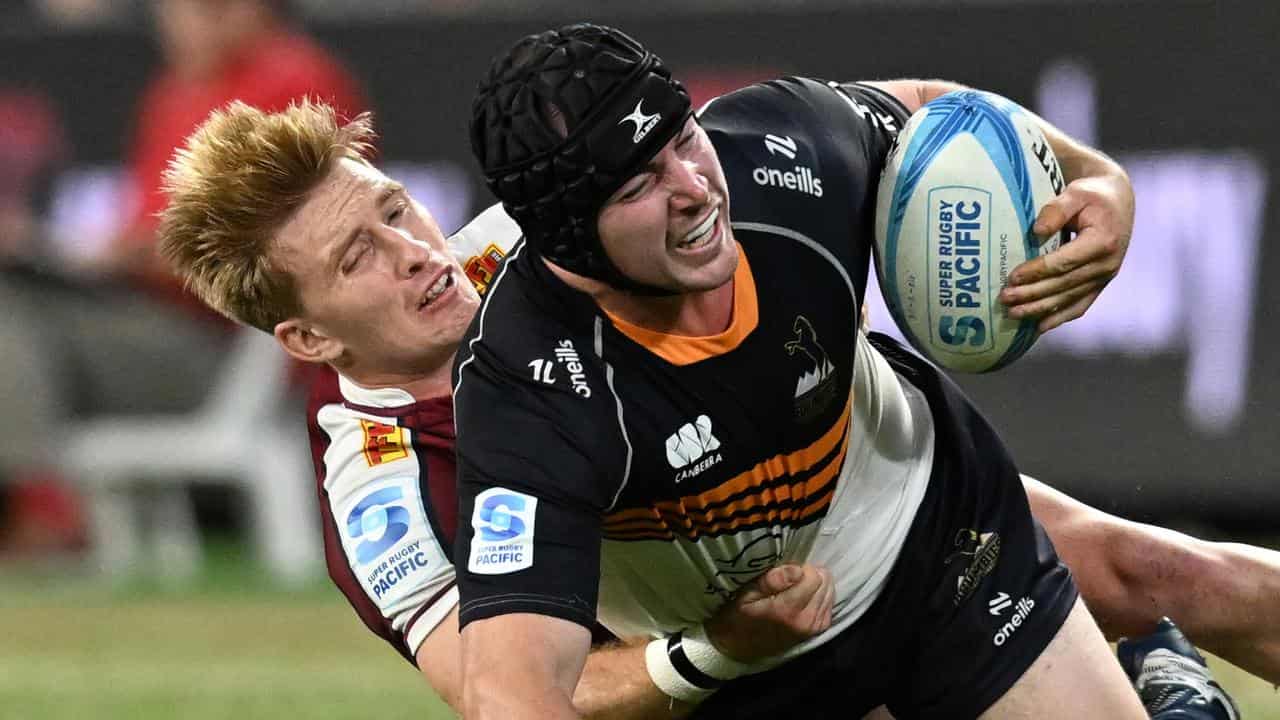 Lachlan Lonergan (right) injured in tackle by Reds' Tate McDermott.