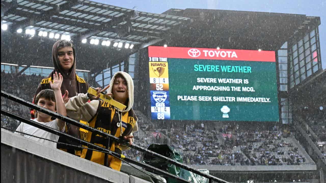 Fans at the MCG in the rain.