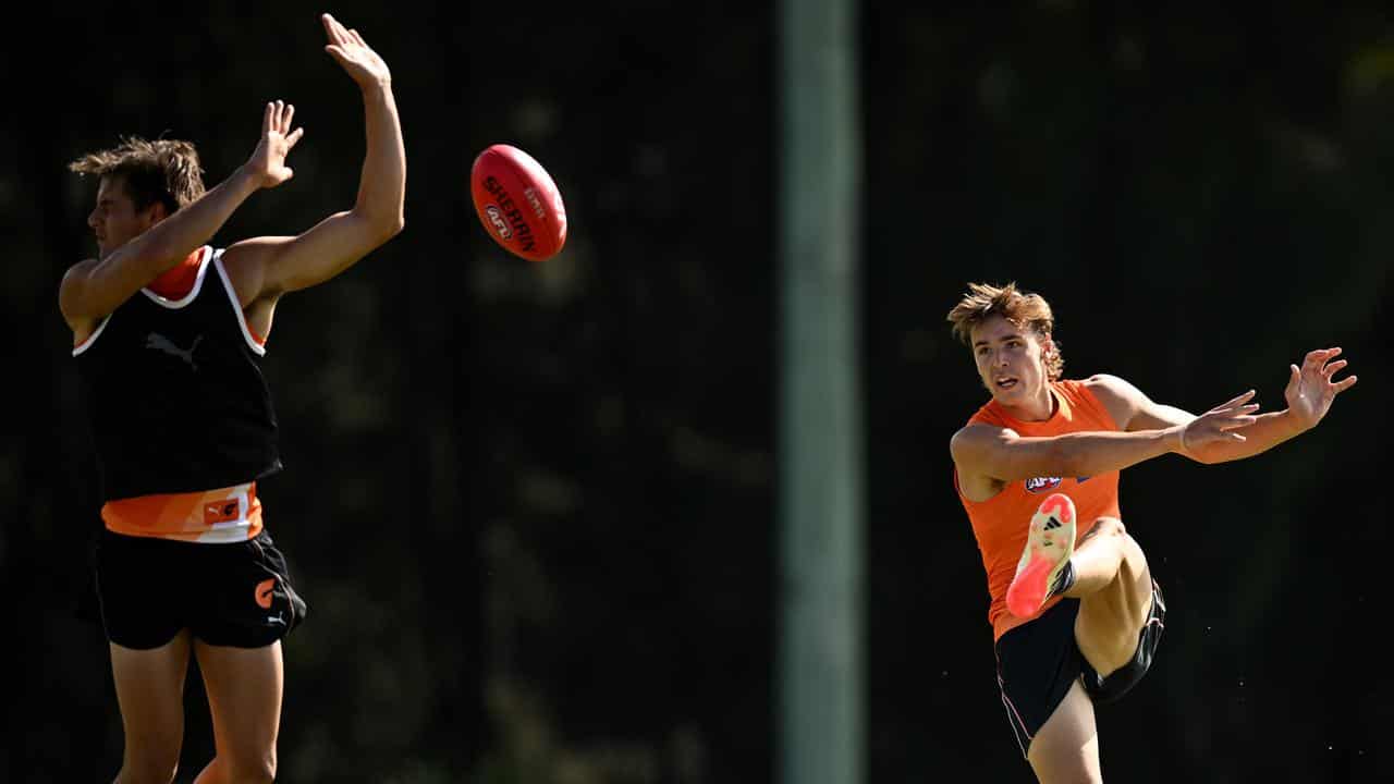 Cadman (right) goes through his paces at training with the Giants.