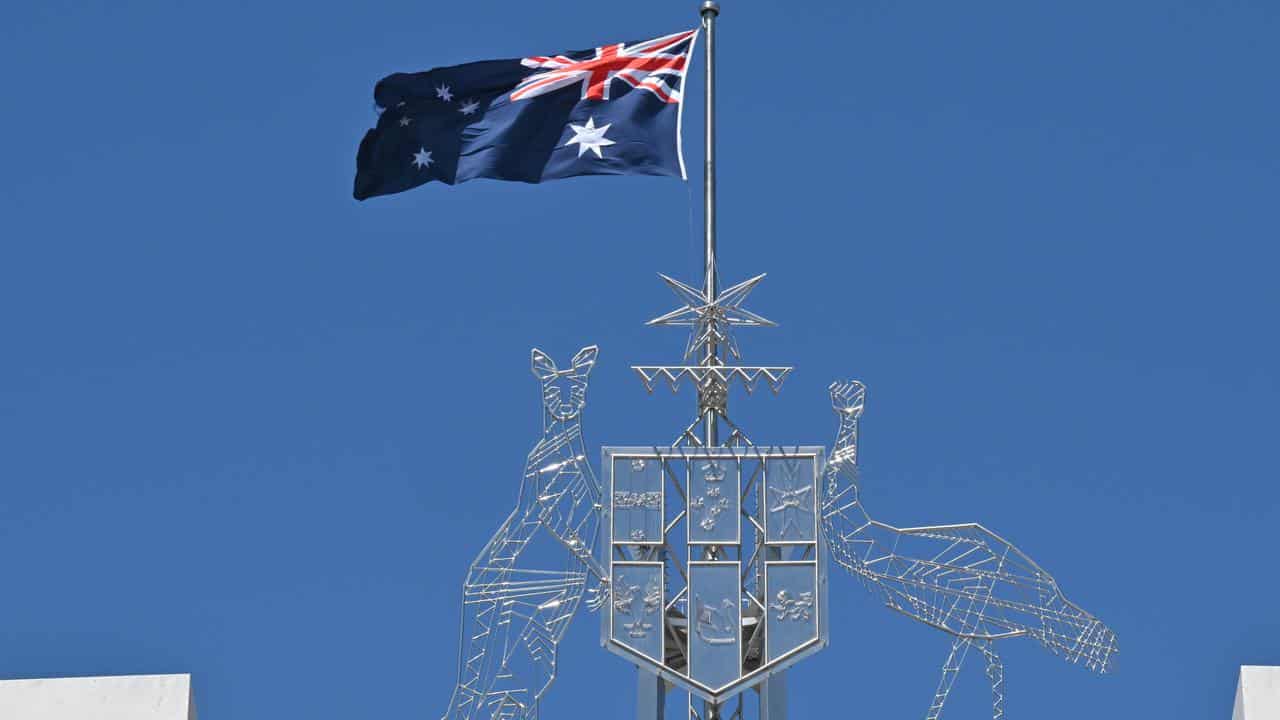 The coat of arms and the flagpole at Parliament House in Canberra