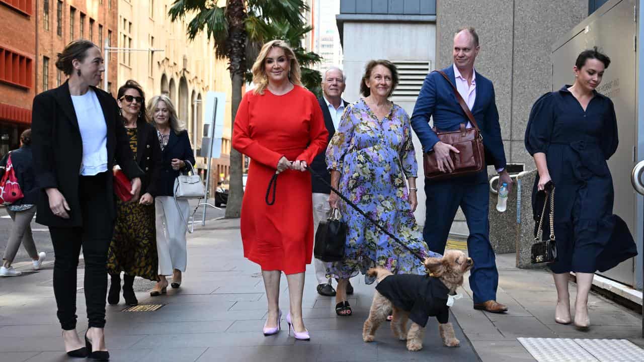 Gina Edwards, with her Cavoodle Oscar, arrives at the Federal Court