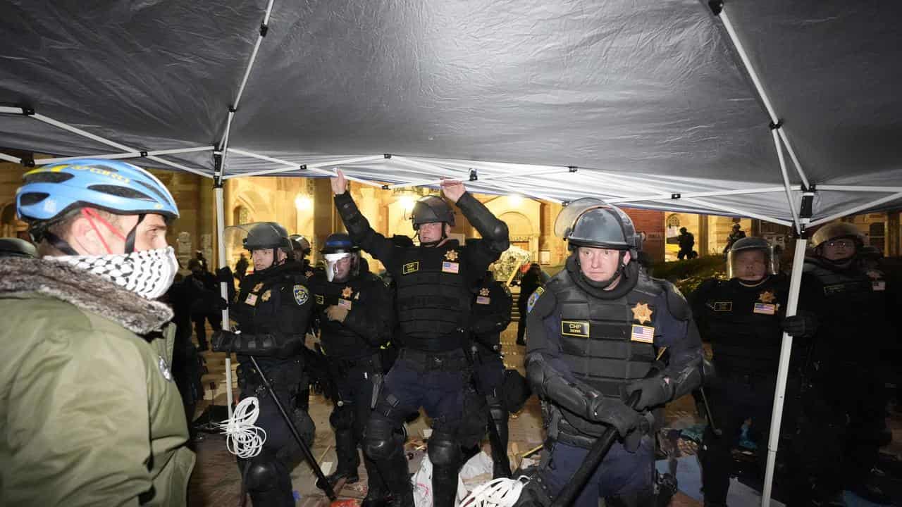 Police enter an encampment of pro-Palestinian protesters at UCLA