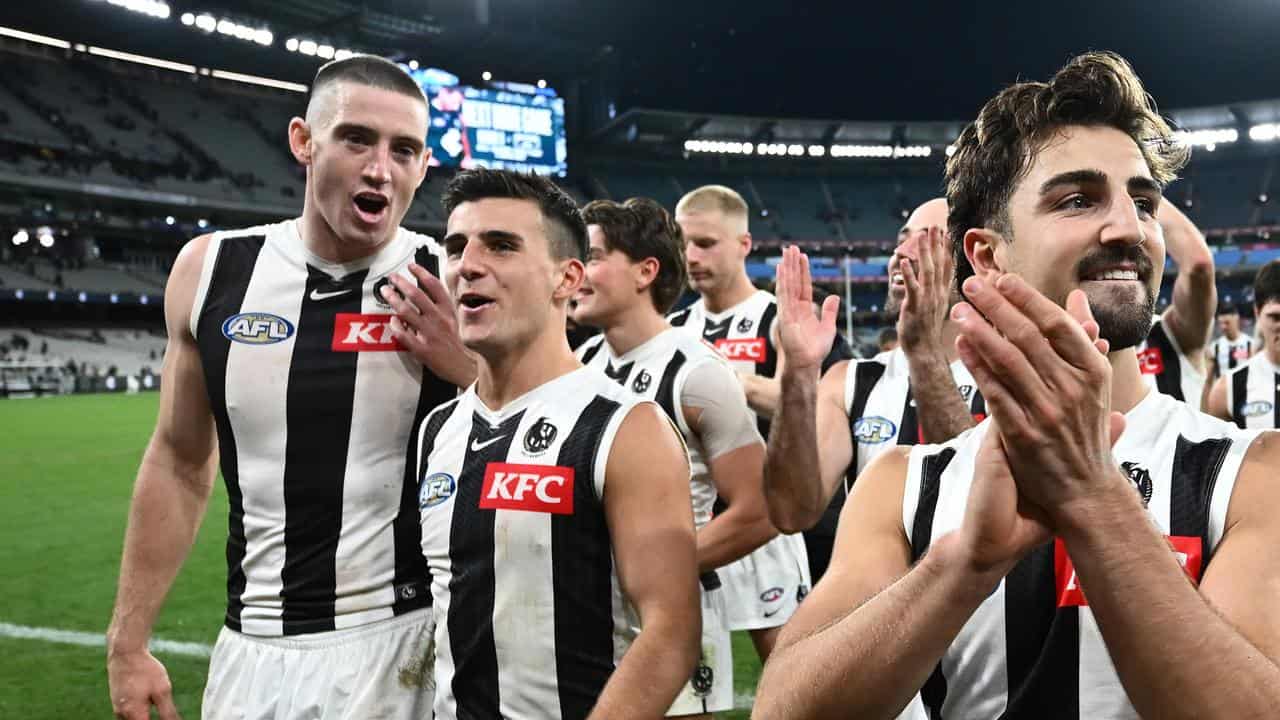 Collingwood players leave the field after their win over Carlton.