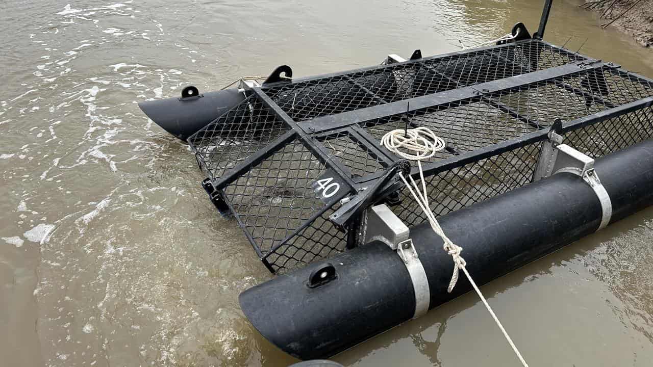 A large cage in a creek.