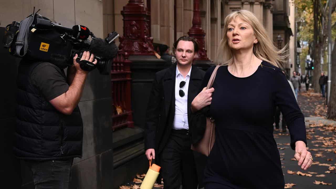 Melanie Lynn (right), wife of Greg Lynn, leaves the Supreme Court