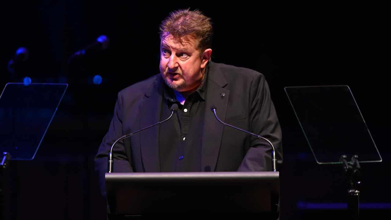 Stuart Mitchell speaks during a State Memorial Service for his father