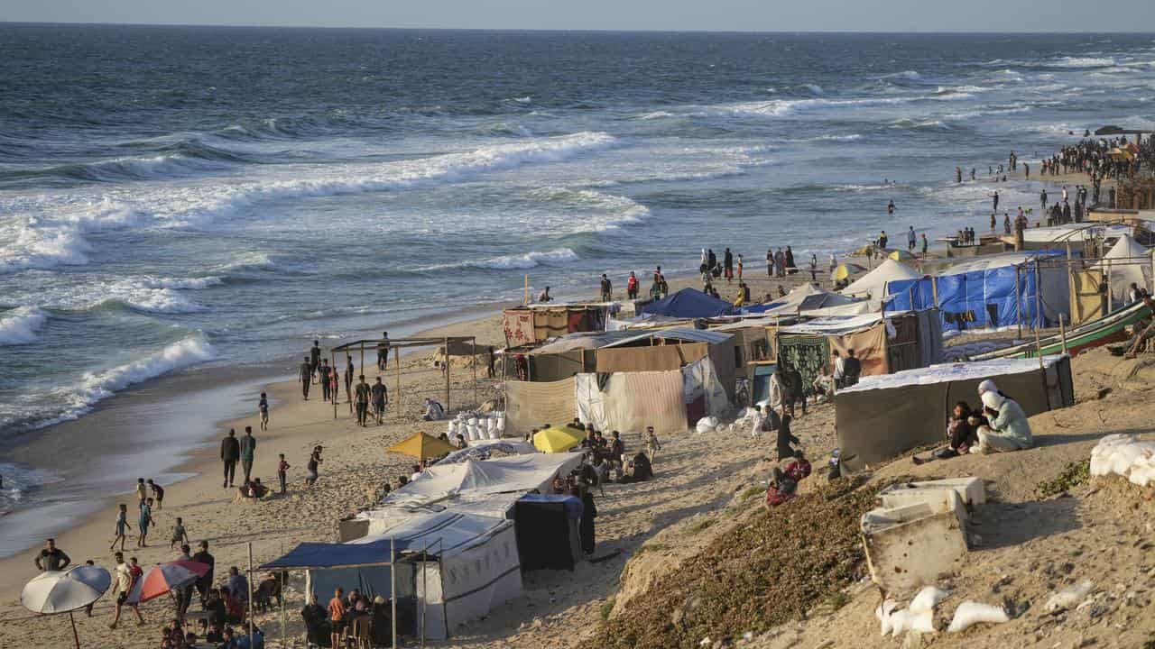 Palestinians displaced by the Israeli offensive in a beach camp