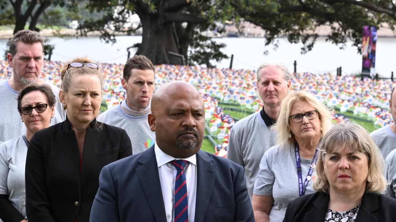 NSW Teachers Federation President Henry Rajendra (centre left)