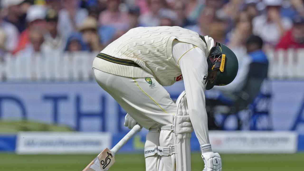 Nathan Lyon bent over in pain during his Lord's innings.