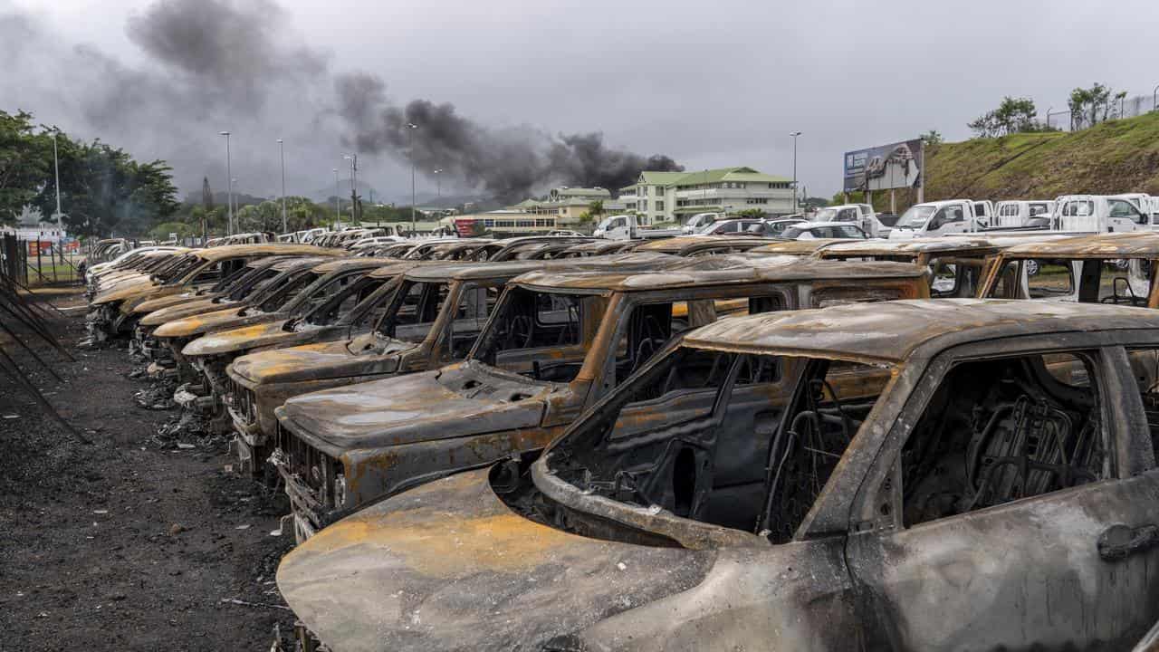 Burnt cars after unrest in Noumea