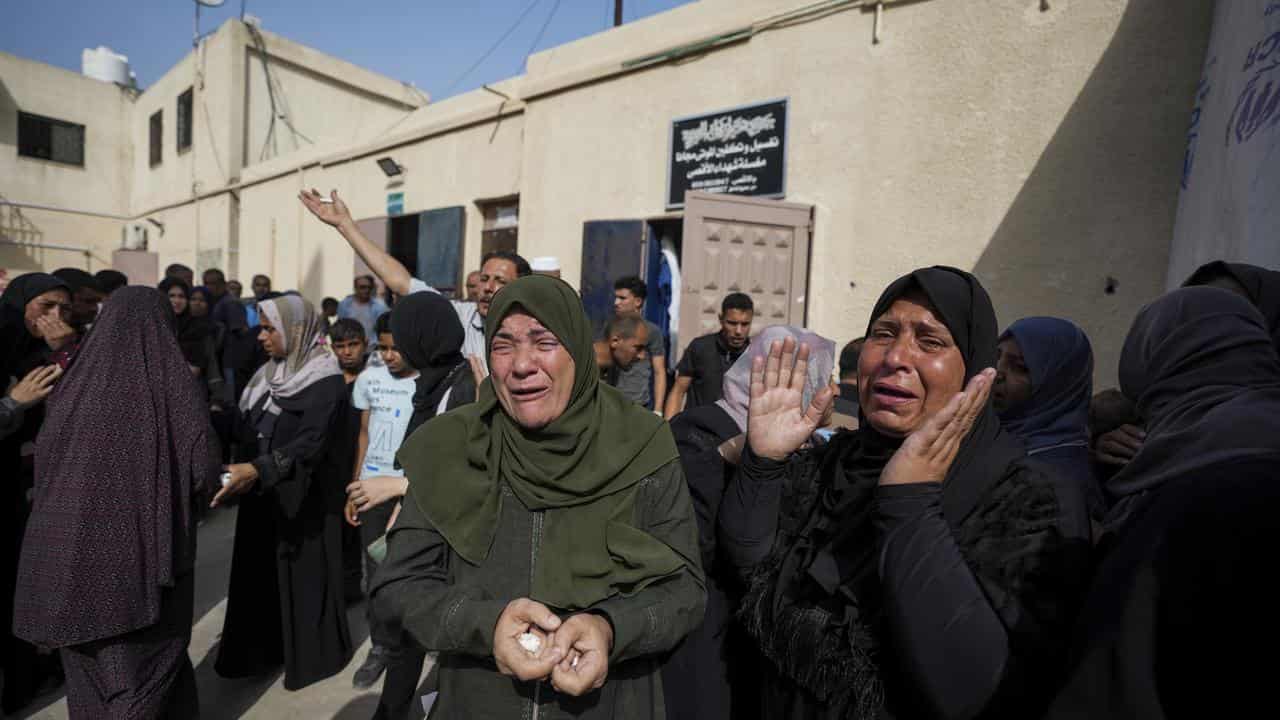 Palestinians mourn their relatives