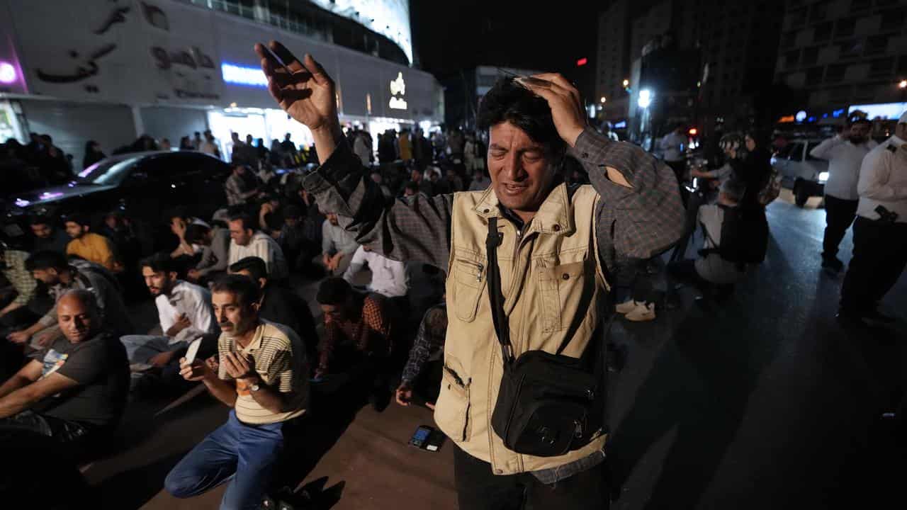 People pray for President Ebrahim Raisi in Vali-e-Asr square, Tehran