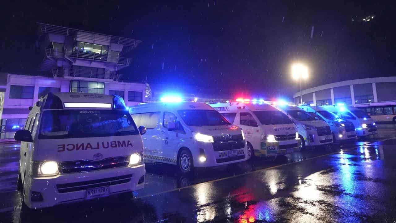 Ambulances wait to carry passengers from a London-Singapore flight