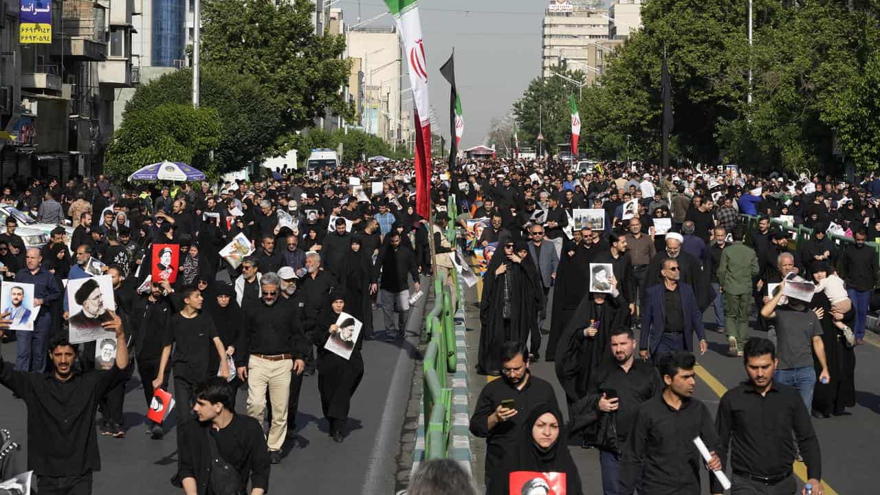 Tens of thousands of Iranians march in a funeral procession