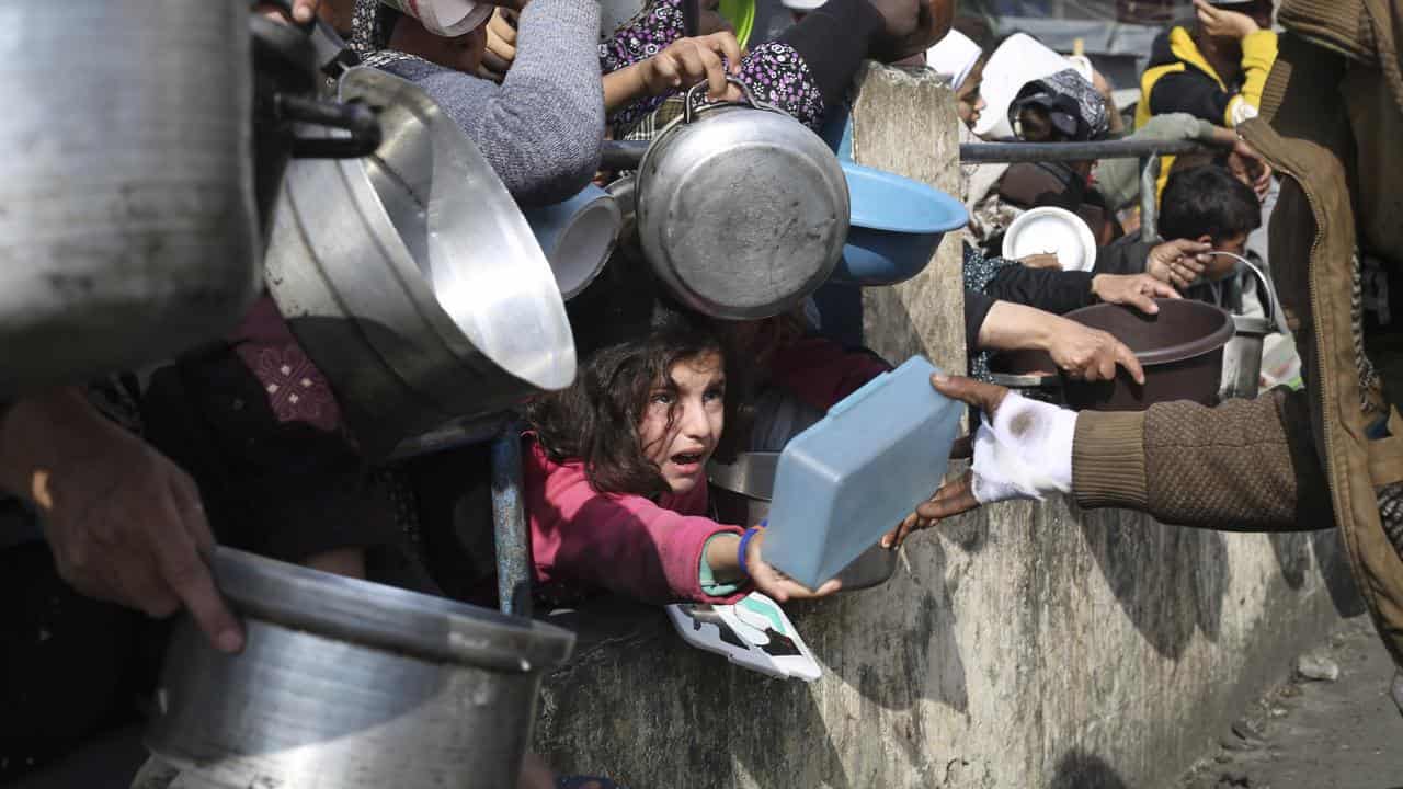 Palestinians line up for food aid