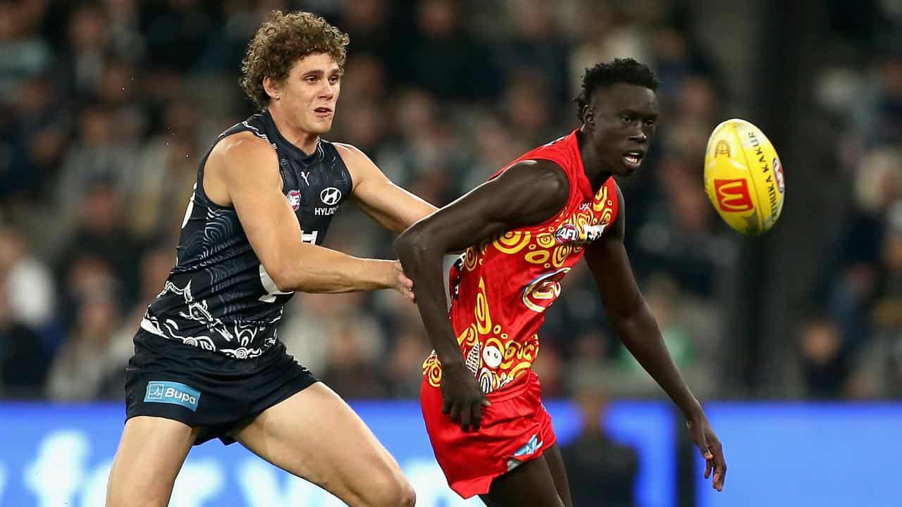 Charlie Curnow of Carlton and Mac Andrew of the Suns. 