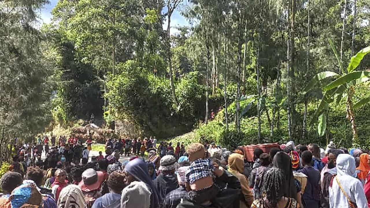 Villagers carry a coffin during a funeral procession in Yambali