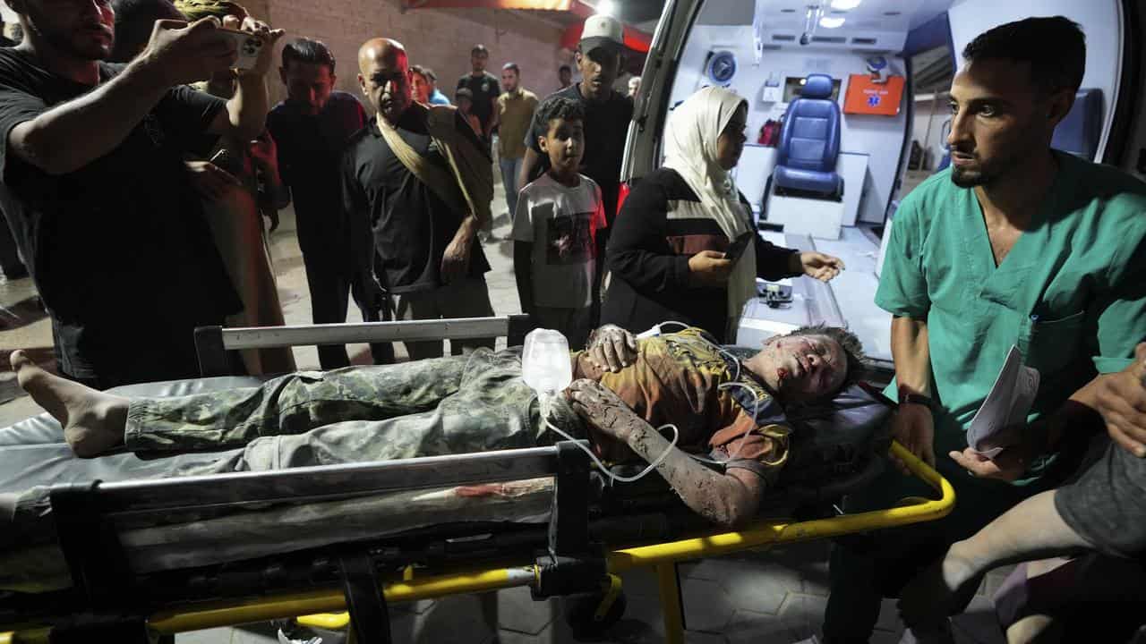 A wounded Palestinian is brought to Al Aqsa hospital, Gaza Strip