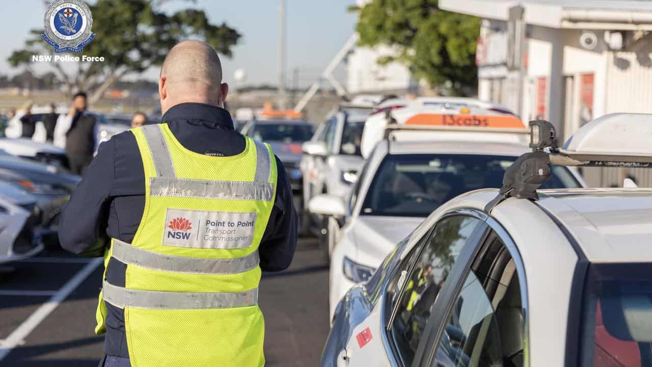 Officials checking e-tags at Sydney airport.